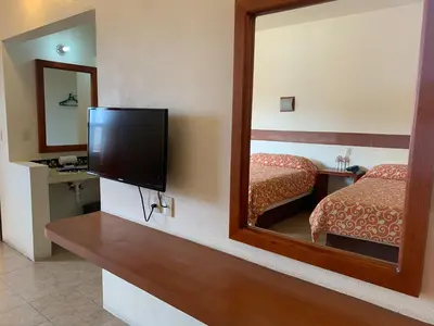 Una televisión o centro de entretenimiento en Hotel Posada Don Ramon