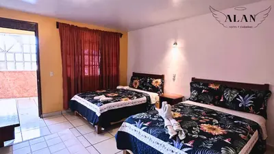 Cama o camas de una habitación en Hotel y Cabañas Alan