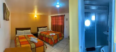 Cama o camas de una habitación en Hotel y Cabañas Alan