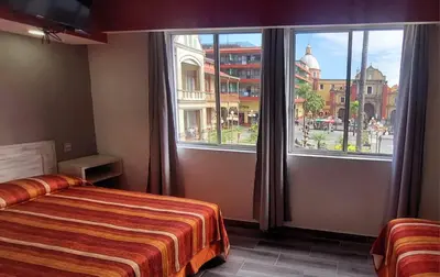 Cama o camas de una habitación en HOTEL PLAZA PALACIO