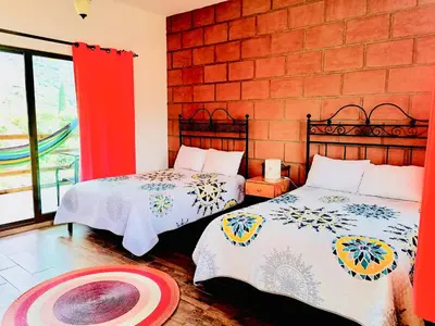 Cama o camas de una habitación en Hotel Boutique Jardín de Flores
