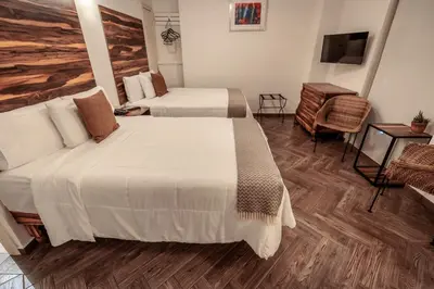 Cama o camas de una habitación en Hotel Tabáa Oaxaca