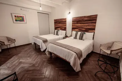Cama o camas de una habitación en Hotel Tabáa Oaxaca