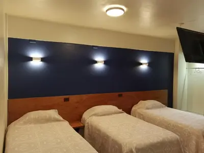 Cama o camas de una habitación en Hotel Edén