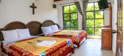 Cama o camas de una habitación en Hotel Hacienda Xico Inn