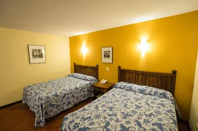 Cama o camas de una habitación en Hotel Real de Naturales
