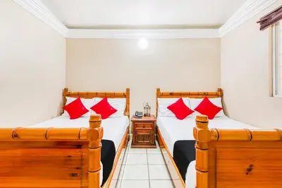 Cama o camas de una habitación en Capital O Colina Dorada