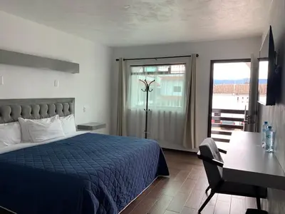 Cama o camas de una habitación en HOTEL LOS PORTALES CHIGNAHUAPAN