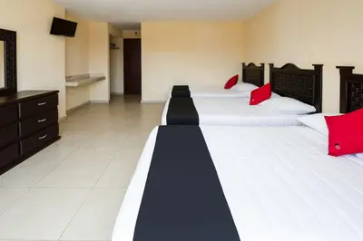 Cama o camas de una habitación en Capital O Hotel Los Caracoles, Acapulco