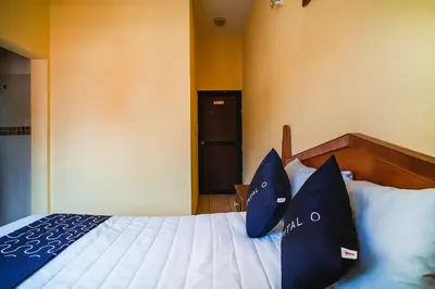 Cama o camas de una habitación en Capital O Hotel Aurora, Tuxtla Gutiérrez