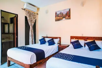 Cama o camas de una habitación en Capital O Hotel Aurora, Tuxtla Gutiérrez