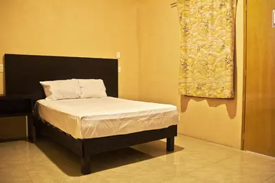 Cama o camas de una habitación en OYO Hotel Trigos De Oro,San Luis Teolocholco Park