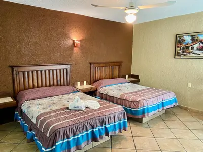 Cama o camas de una habitación en Hotel Cabañas Santa Cruz