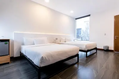 Cama o camas de una habitación en Urban Puebla by Grupo Amber