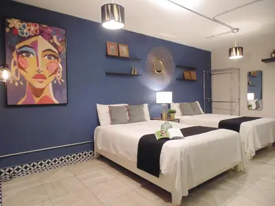Cama o camas de una habitación en Suites Viveros Coyoacán I Hospedaje a tu medida