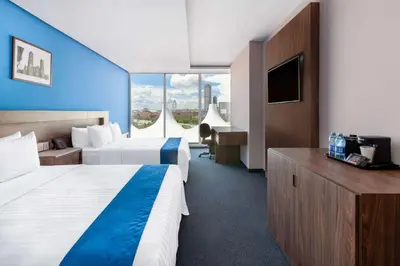 Cama o camas de una habitación en Wyndham Puebla Angelopolis