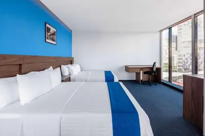 Cama o camas de una habitación en Wyndham Puebla Angelopolis