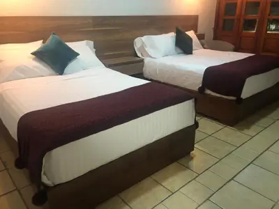 Cama o camas de una habitación en Hotel Orquídea