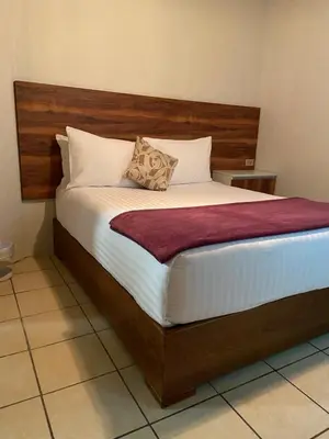 Cama o camas de una habitación en Hotel Orquídea