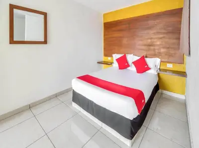 Cama o camas de una habitación en OYO Hotel Familiar Tollan Cholula