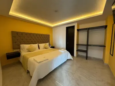 Cama o camas de una habitación en OYO Hotel Familiar Tollan Cholula