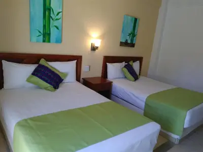 Cama o camas de una habitación en Hotel Arenas del Pacifico
