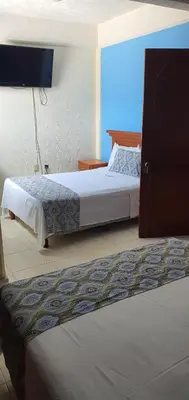 Cama o camas de una habitación en Hotel Dorado a una calle de Playa Regatas y el Malecon