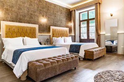 Cama o camas de una habitación en voco Royalty Puebla Downtown by IHG
