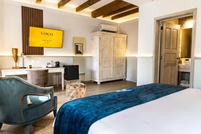 Cama o camas de una habitación en voco Royalty Puebla Downtown by IHG