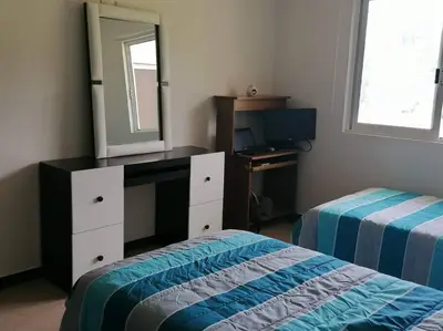Cama o camas de una habitación en Departamento en condominio Diamante Turquesa