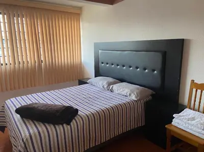 Cama o camas de una habitación en Departamento con gran área verde