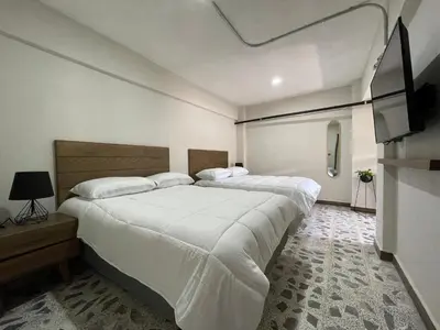 Cama o camas de una habitación en Estacion Alameda Downtown