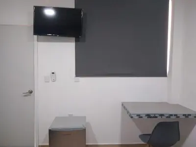 Una televisión o centro de entretenimiento en Garden Suites Comalcalco