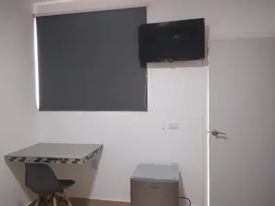 Una televisión o centro de entretenimiento en Garden Suites Comalcalco