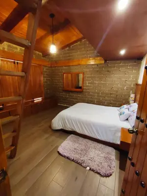 Cama o camas de una habitación en cabaña el rio la grande