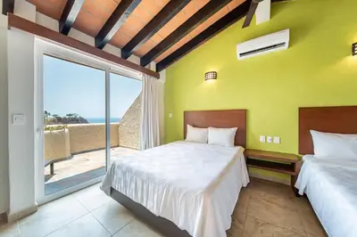 Cama o camas de una habitación en Villas Coral Huatulco