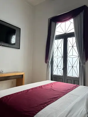 Cama o camas de una habitación en Hotel Alhaja Puebla Centro Histórico