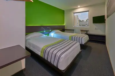 Cama o camas de una habitación en City Express Junior by Marriott Puebla FINSA