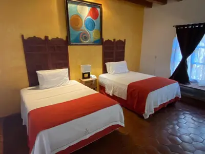 Cama o camas de una habitación en La Joyita Cuernavaca