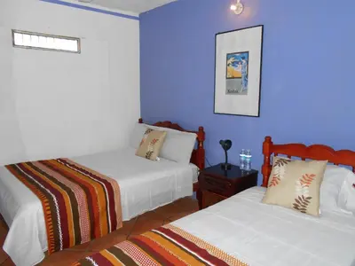 Cama o camas de una habitación en Hotel y Bungalows Monteverde