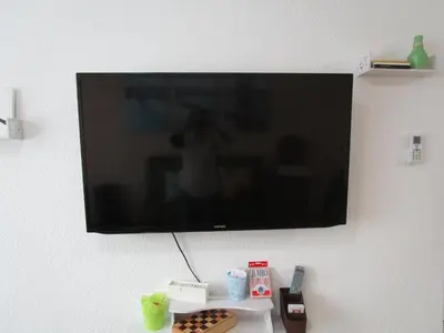 Una televisión o centro de entretenimiento en Casa Palmera con Aire acondicionado Alberca Wifi cocina y TV