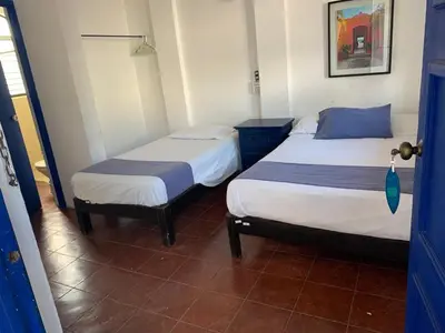 Cama o camas de una habitación en MayFlower Hotel & Hostal