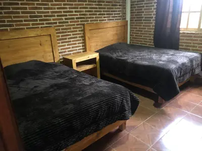 Cama o camas de una habitación en Cabañas El Manantial