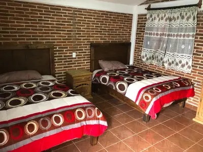 Cama o camas de una habitación en Cabañas El Manantial