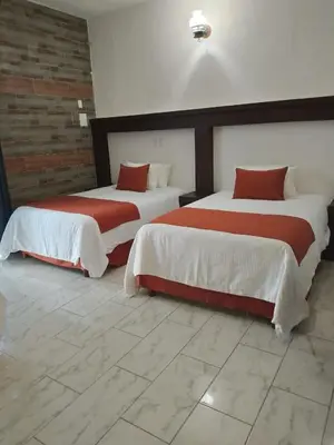 Cama o camas de una habitación en Pineda Real HOTEL