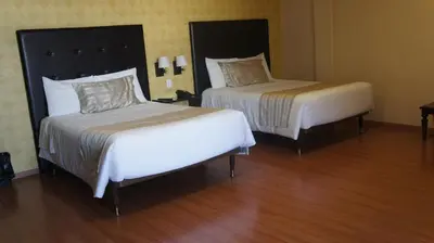 Cama o camas de una habitación en Hotel Suites Teziutlan