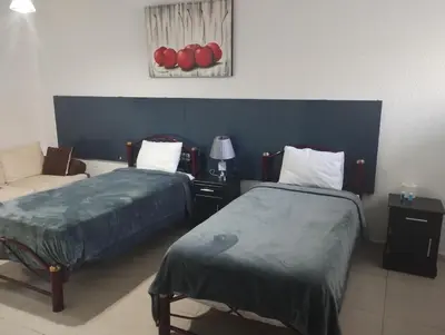 Cama o camas de una habitación en PROVENZA HOTEL & SUiTES