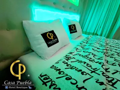 Cama o camas de una habitación en Hotel Temático Casa Puebla