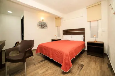 Cama o camas de una habitación en Capital O Hotel Boutique Las Torres
