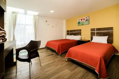 Cama o camas de una habitación en Capital O Hotel Boutique Las Torres